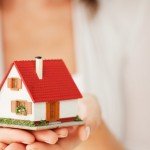 Woman's Hands Holding a Little House - Isolated